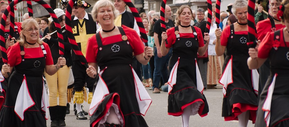 Female morris dancers in black and red costume